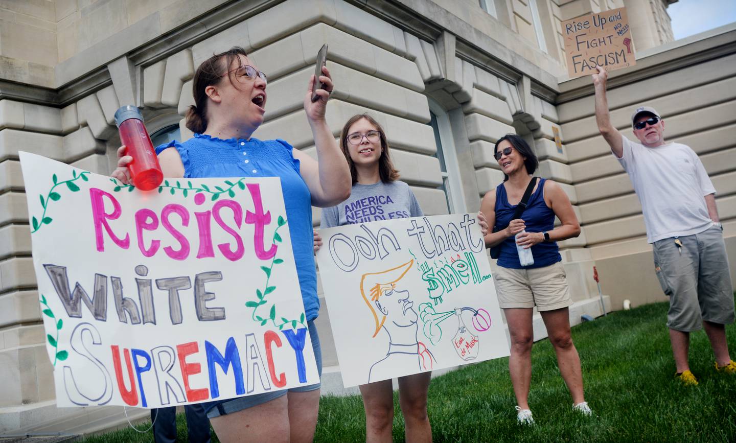 Protestors chant while displaying anti-Trump signs during the "No Kings" protest June 14 at the Jasper County Courthouse in Newton.