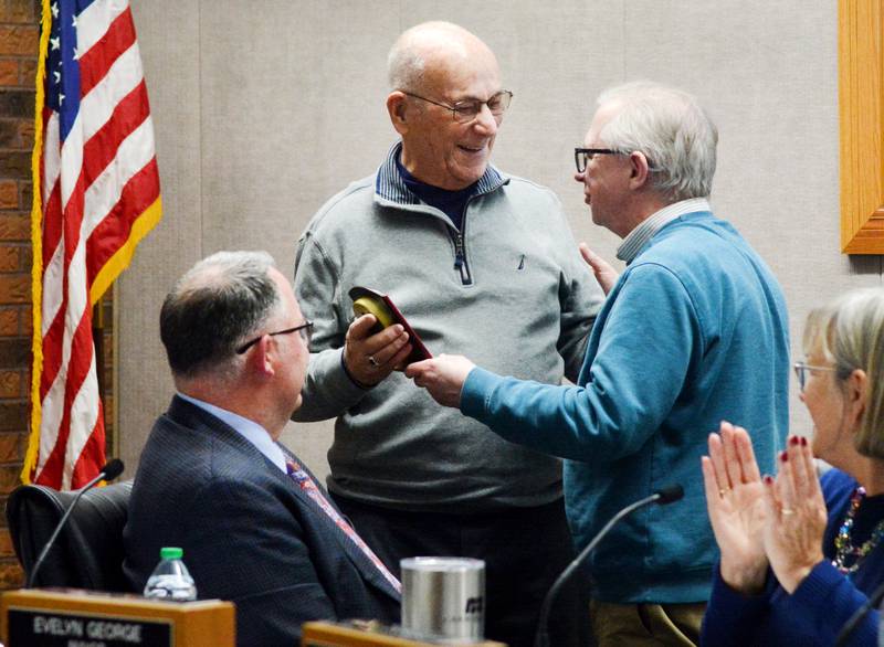 Steve Mullan receives a timepiece from Mark Hallam recognizing his service to the City of Newton. Mullan exited the Newton City Council this past week. He has assisted the city council from 2006 until 2021 and then again from 2024 to 2025.