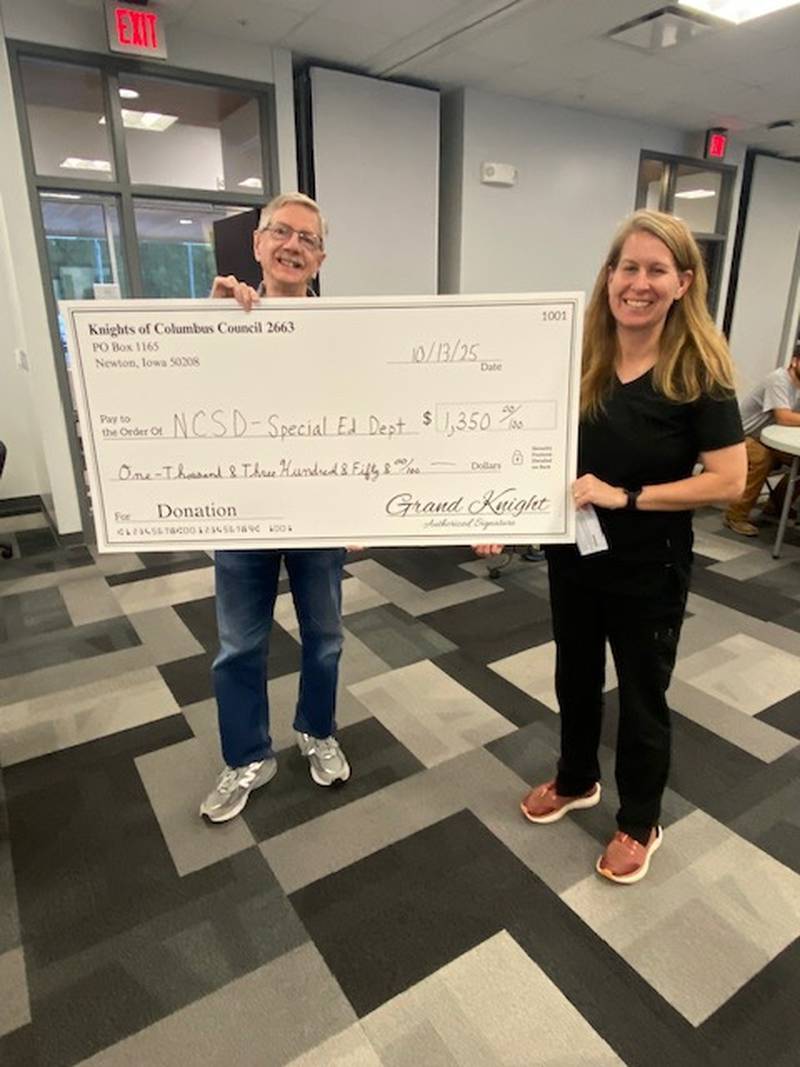 Bruce Corlew, Deputy Grand Knight of the Knights of Columbus, presents Robyn Friedman, Newton Community Schools Board President with a $1,350 check.