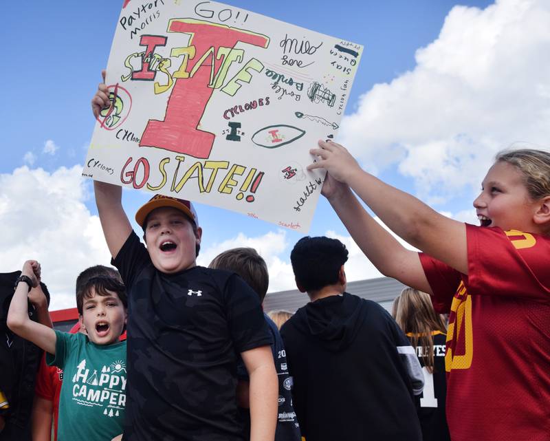 Students wearing Cyclone and Hawkeye apparel pose for pictures on Sept. 4 outside Berg Middle School. The whole study body was invited to welcome RVTV to town.