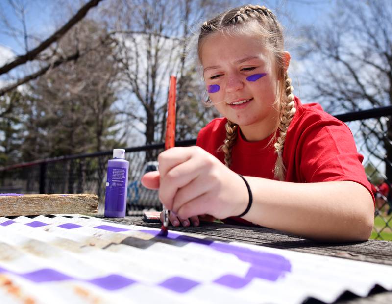 Newton students on May 4 painted Christmas light displays for the city's Maytag Park Holiday Lights during Red Pride Service Day.