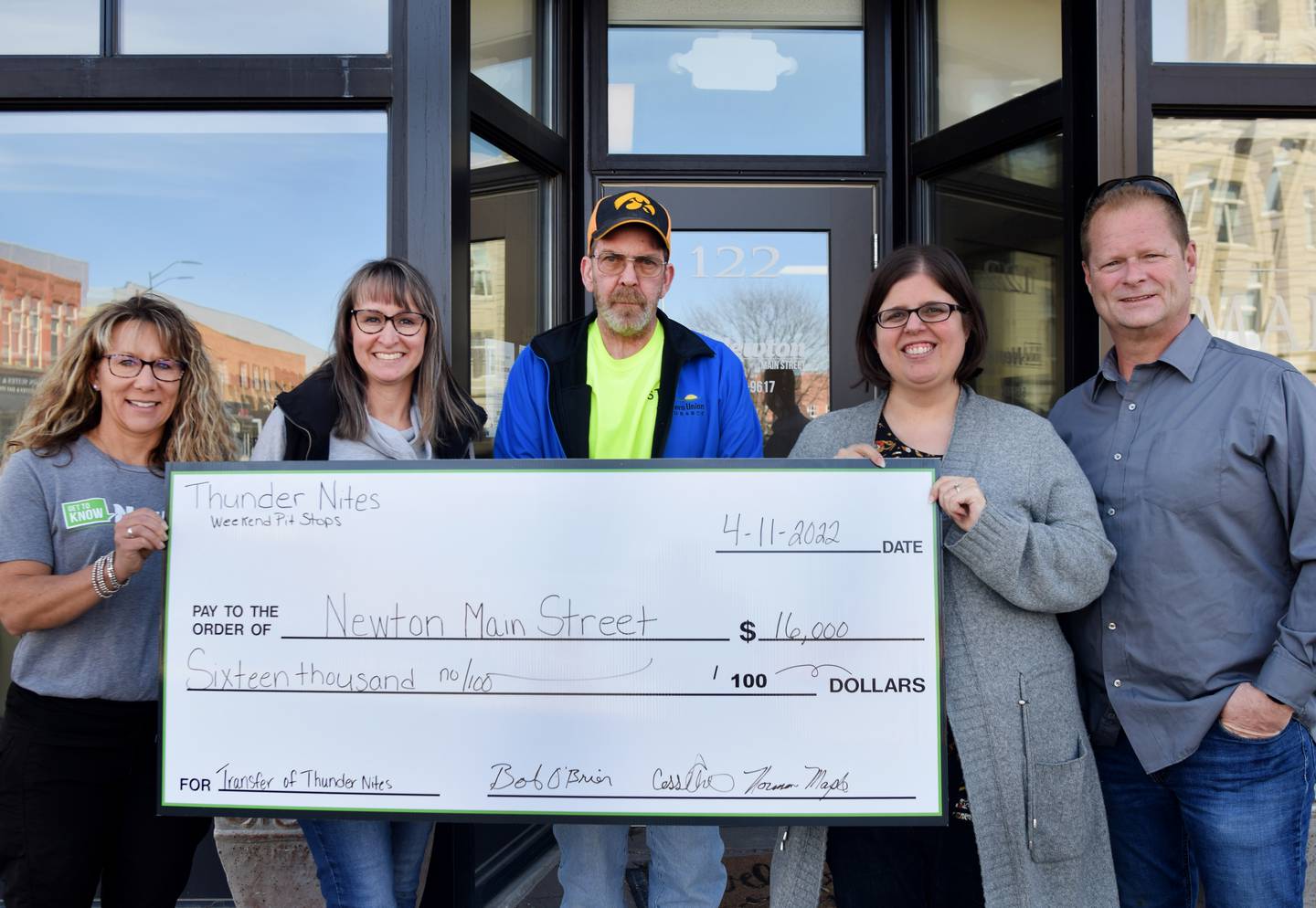 From left: Laurie Moffit and Erin Yeager of Newton Main Street, and Norman Maple, Cassie Archibald and Bob O'Brien of Thunder Nites pose for a picture with a $16,000 donation on April 11 outside the Main Street office. Thunder Nites organizers have handed off the community event to Main Street.
