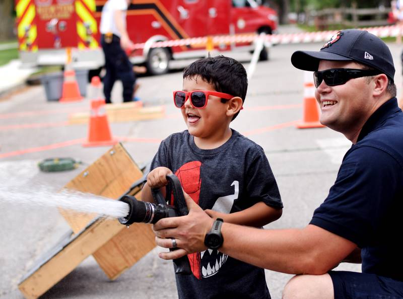 Local first responders show off emergency vehicles and have kids participate in an obstacle course as part of Safety Fest during Newton Fest on Saturday, June 10 at Maytag Park.