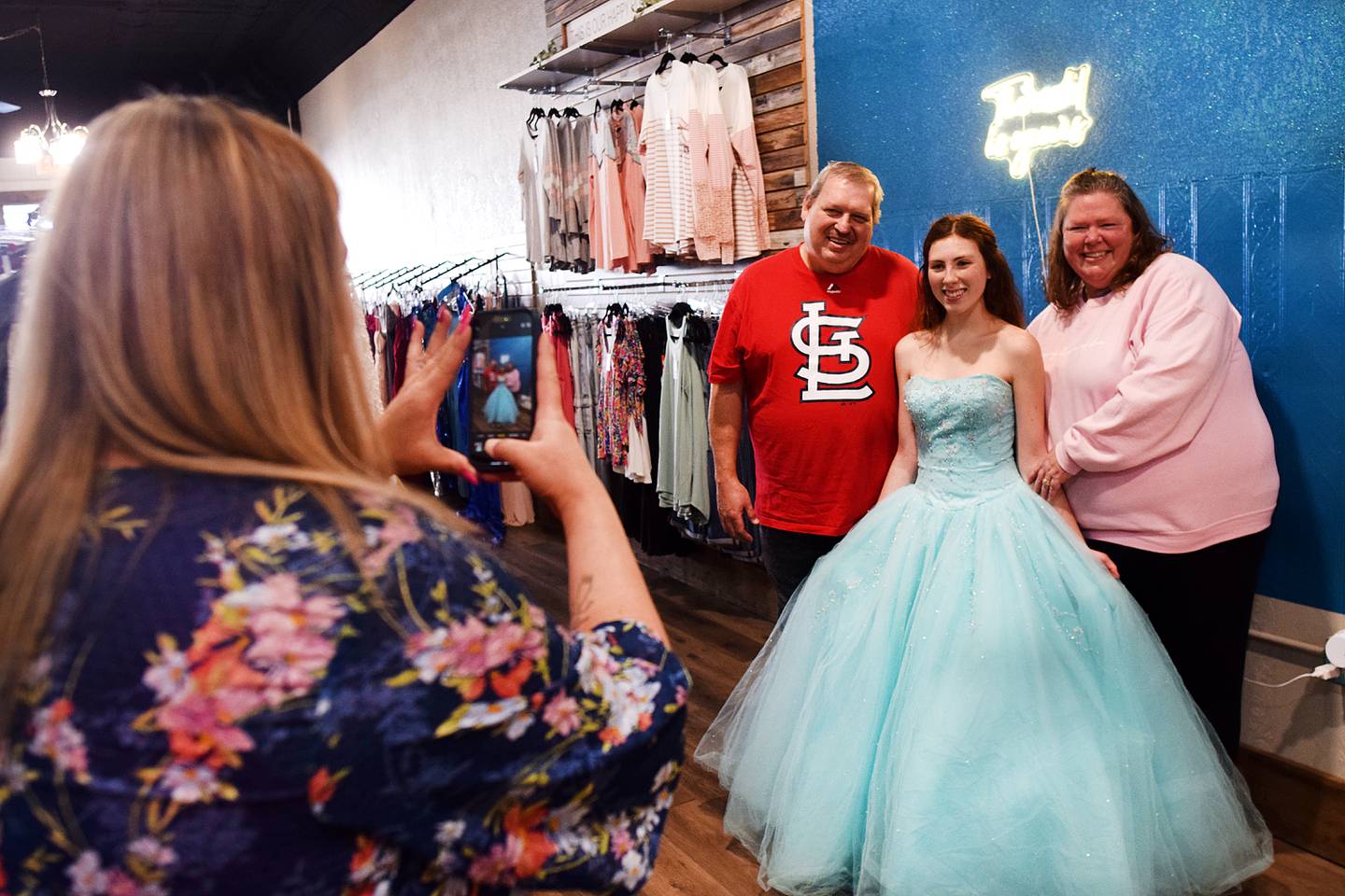 Cassidy Thompson, 16, of Albia High School poses for pictures after picking out her free prom dress during a giveaway on March 16 at Daughters Boutique Color Bar & Beauty Salon in Newton. The event was established by 17-year-old Lydia Schwaller of Grand View Christian School, who has been collecting dresses for years.