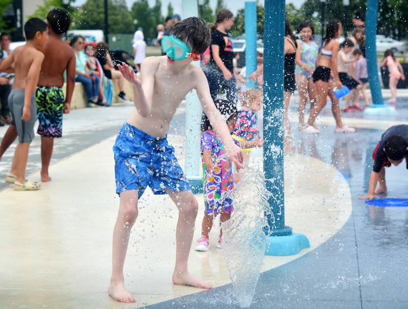Families and children enjoy the new splash pad facilities. The Greater Newton Area Chamber of Commerce, Newton Main Street and the City of Newton held a ribbon cutting ceremony for the splash pad on June 6.