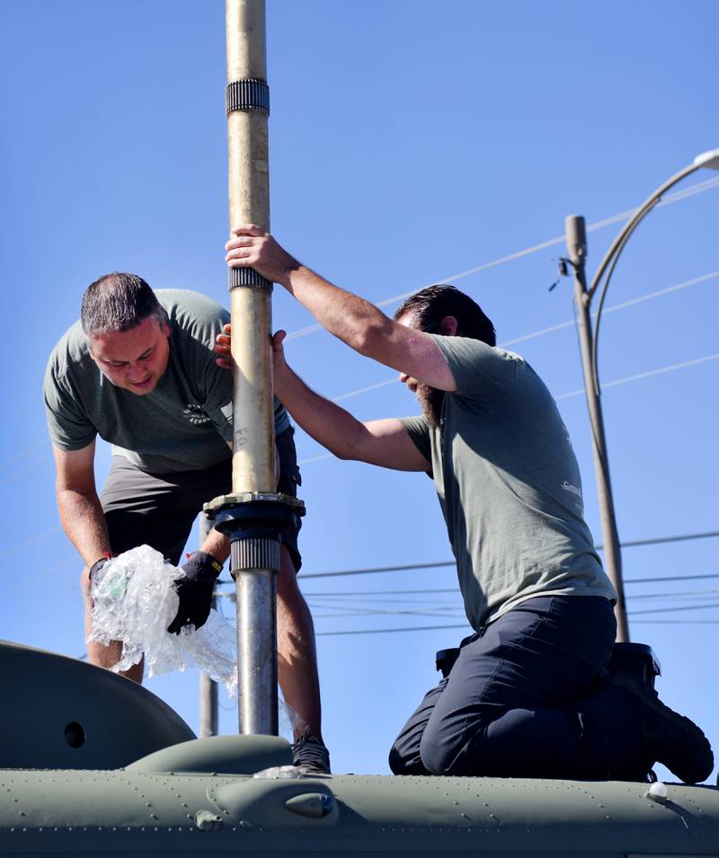 Crews from Midwest Aerospace prepare a  Huey helicopter monument on Sept. 30 in Baxter.