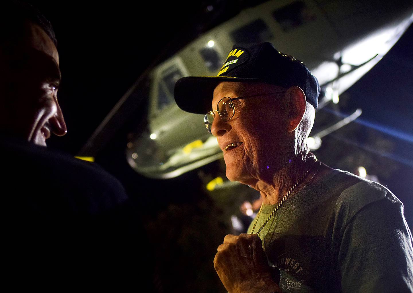 Lynn Harnden, a retired Lt. Colonel of the U.S. Army, speaks with Luke Schreiber of Midwest Aerospace after the Huey helicopter was successfully installed as a memorial to Vietnam War veterans.
