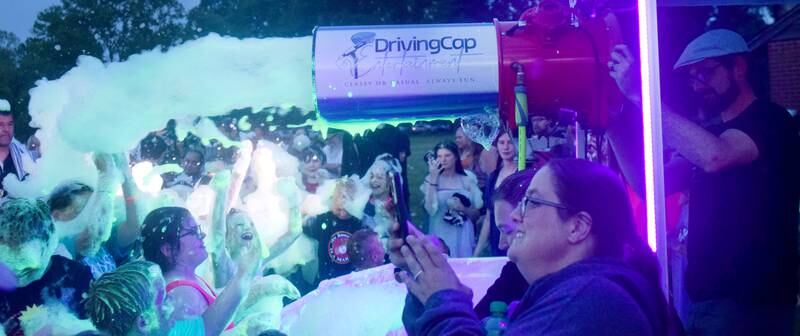 Kids participate in Driving Cap Entertainment's UV Glow Foam Party during Newton Fest on June 9 in Maytag Park in Newton.