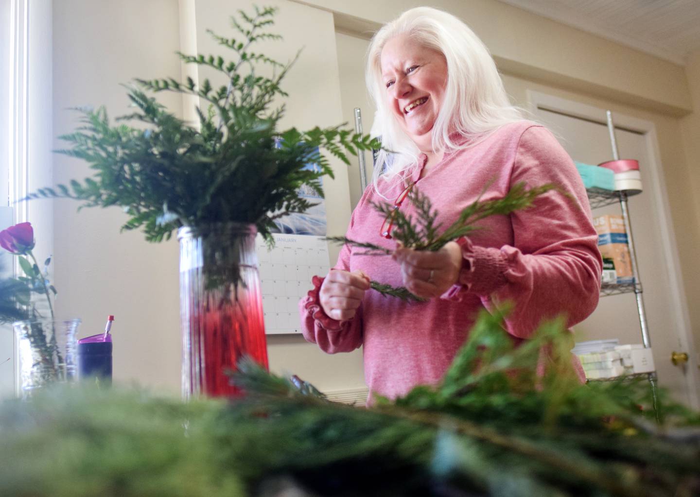 Jennifer Zimmerman, owner of Blooms by Design, prepares a flower arrangement. The new flower shop opened this past week in Newton.