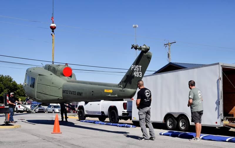 Crews from Midwest Aerospace and Dave's Crane & Wrecker Service help unload a Huey helicopter on Sept. 30 in Baxter.