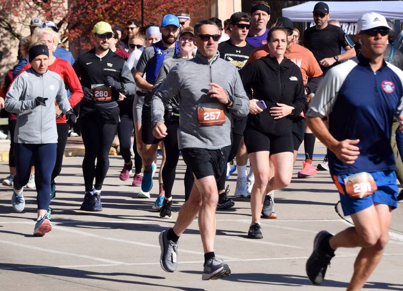 Runners, walkers and young bikers take off for the Run For Her Life 5K organized by nonprofit Phoenix Phase Initiative on April 29 at Legacy Plaza in Newton.