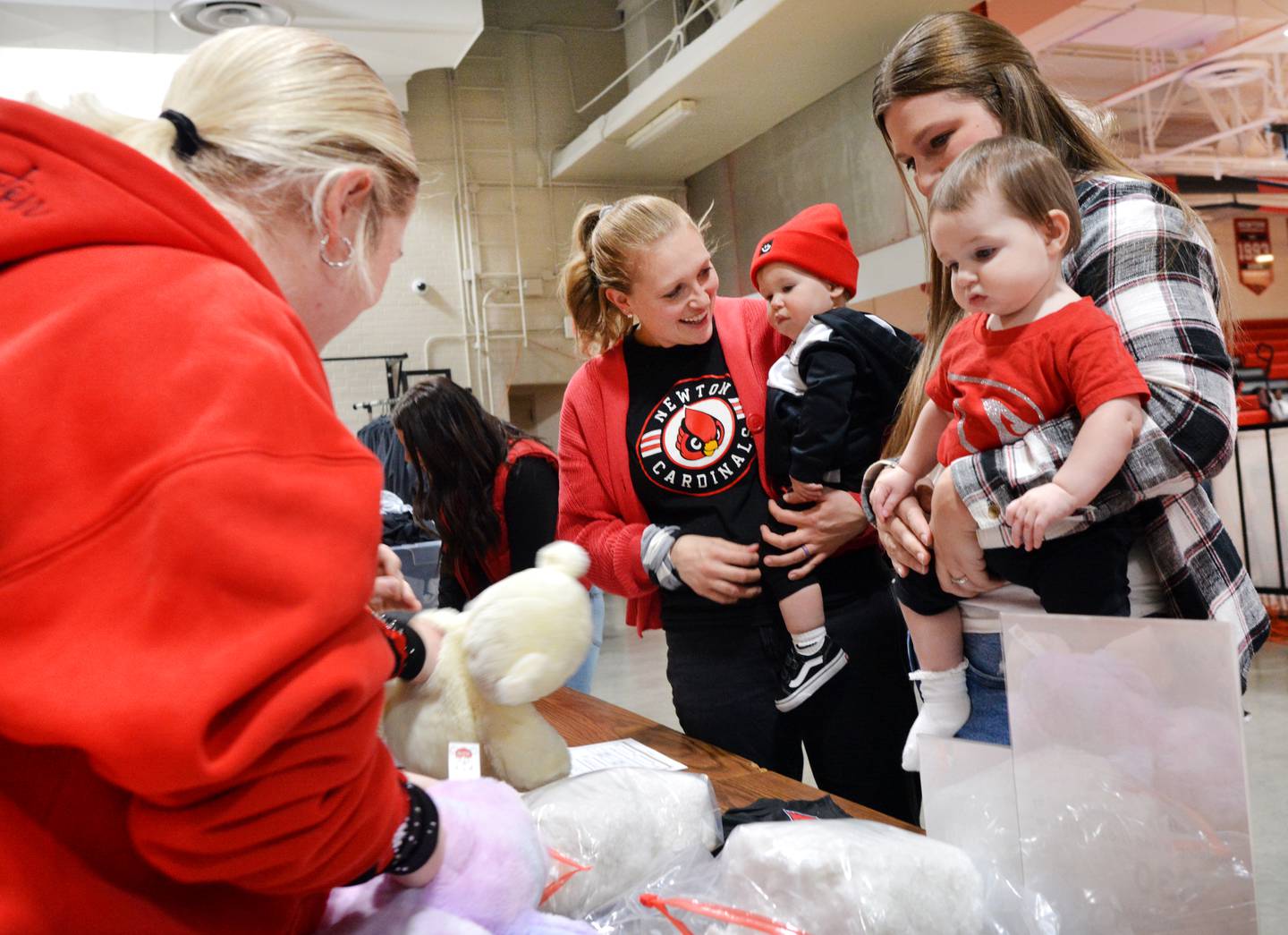 From left: Kaylie Hills and Hannah Bennett bring their little lones to a teddy bear fundraiser for the United Way of Jasper County and Newton Pacesetters on Dec. 12 at Newton High School.