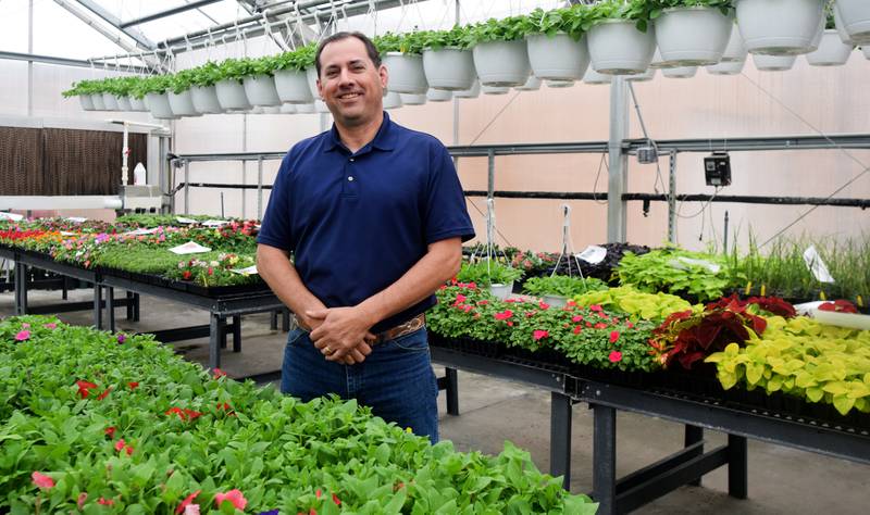 James Horn, the agriculture education teacher at Newton High School and the Newton Future Farmers of America advisor, stands among the flowers growing in the greenhouse, where many students often learn. While there is certainly classroom learning in ag education, students often find themselves in places like the greenhouse or the shop or even in the fields to learn about agriculture.