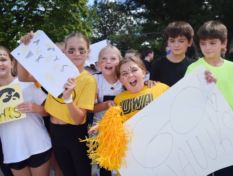 Students wearing Cyclone and Hawkeye apparel pose for pictures on Sept. 4 outside Berg Middle School. The whole study body was invited to welcome RVTV to town.