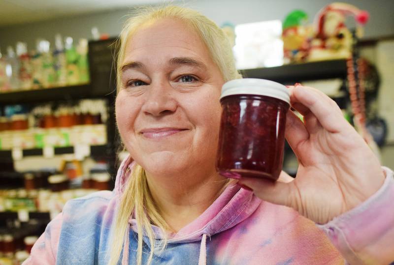 Nancy Woody of Nancy's Canned Creations and Nancy's General Store shows off a jar of the Christmas Jam she has made for the holiday season the past two years.