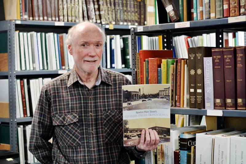 Larry Hurto, a local historian and author of “Stories From Downtown," shows a copy of the new book available through Newton Main Street. The book tells the tales of downtown Newton, dating as far back as the 1800s.