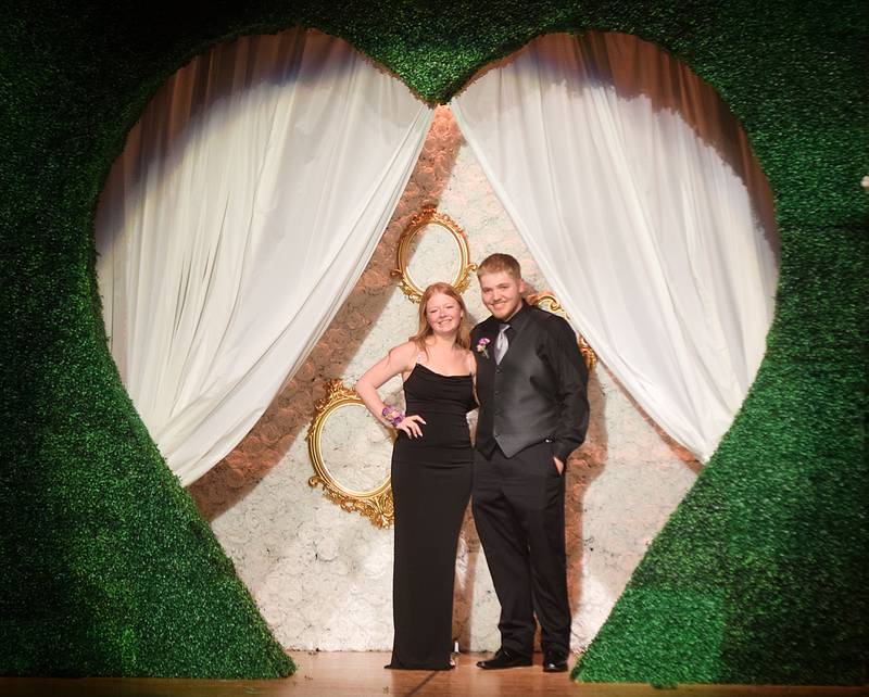 High schoolers pose for photographs before and after entering the auditorium for prom night on Aug. 15 at the Newton High School. Cardinals met for photos at a heart-shaped display on the stage before enjoying the festivities of prom night.