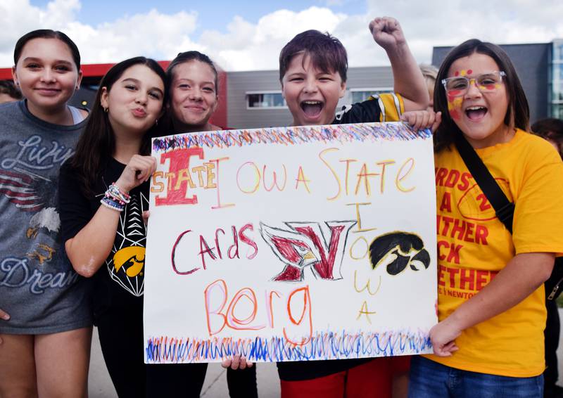 Students wearing Cyclone and Hawkeye apparel pose for pictures on Sept. 4 outside Berg Middle School. The whole study body was invited to welcome RVTV to town.