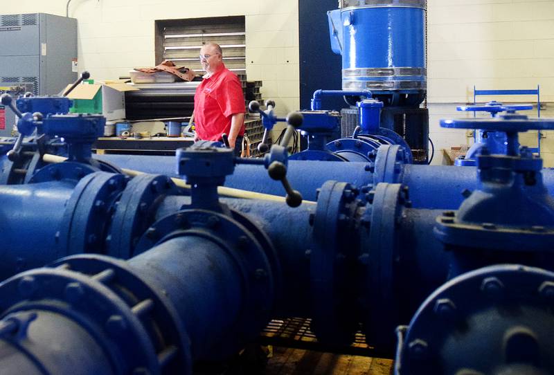 Todd Pierce, supervisor of the Newton WaterWorks Treatment Plant, inspects equipment operating at the water treatment facility.