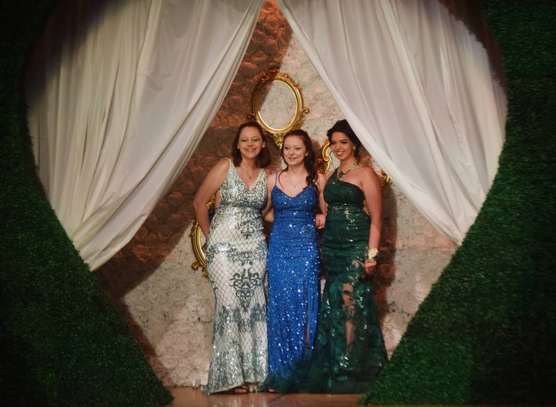 High schoolers pose for photographs before and after entering the auditorium for prom night on Aug. 15 at the Newton High School. Cardinals met for photos at a heart-shaped display on the stage before enjoying the festivities of prom night.
