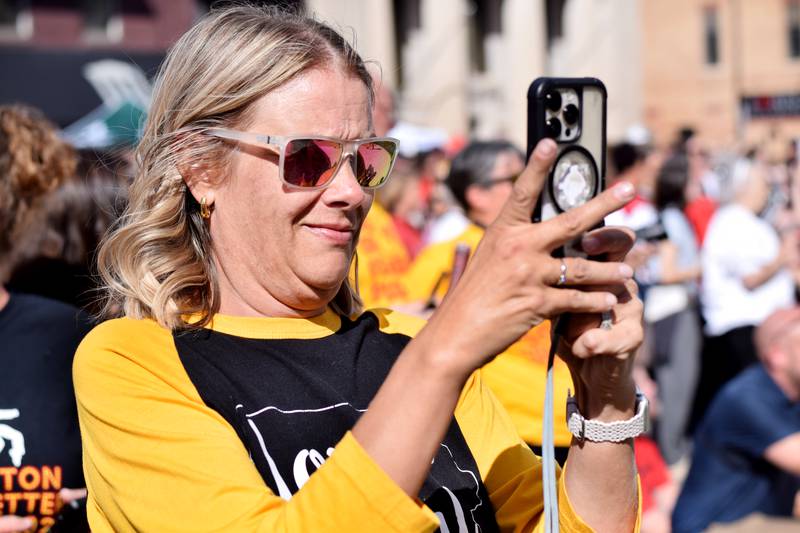 Nicky Lampe takes pictures of the pep rally Sept. 4 in downtown Newton.