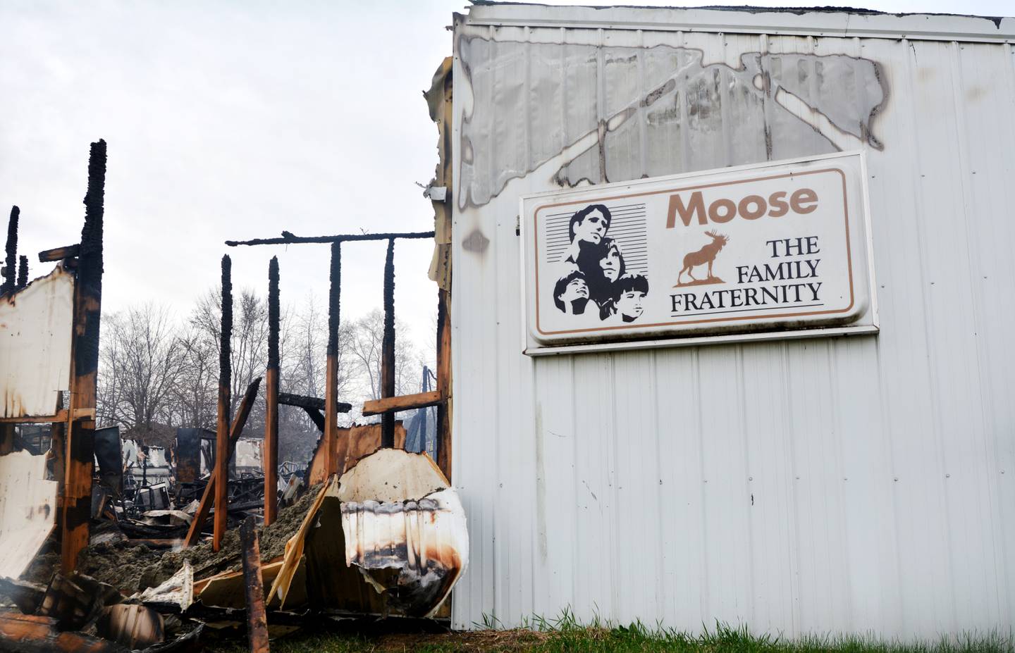 The Newton Moose Lodge sign describing the organization as a "family fraternity" was untouched by the blaze.