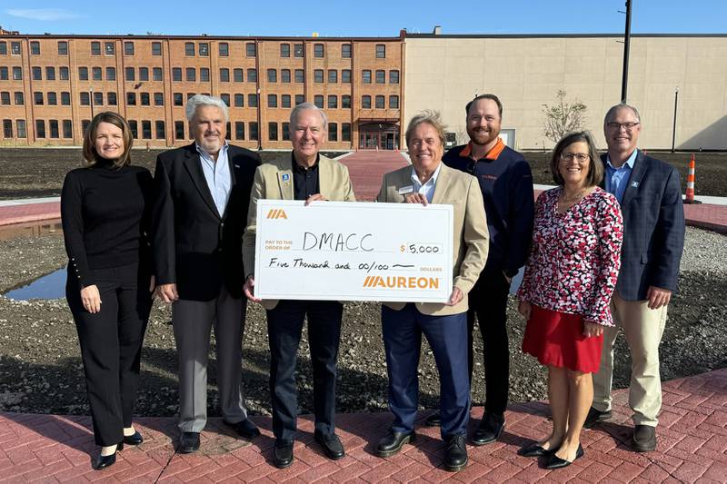 Executives from Aureon present a $5,000 grant check to representatives from DMACC Sept. 23, in front of the new Legacy Plaza Greenspace at the DMACC Newton Campus. Pictured are (from left) Tara Connolly, executive director of the DMACC Foundation; Joe Pugel, chair of the DMACC Board of Directors; Rob Denson, President of DMACC; Ray Warner, manager of Industry Affairs for Aureon; Sean Presnall, sales executive at Aureon; Kim Didier, executive director of DMACC Business Resources; and Bill Peters, executive campus dean at the DMACC Newton Campus.