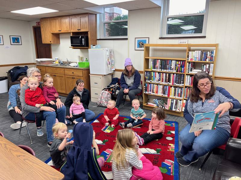 Kim Dyer, Colfax Public Library assistant, share a story with a recent group of children.