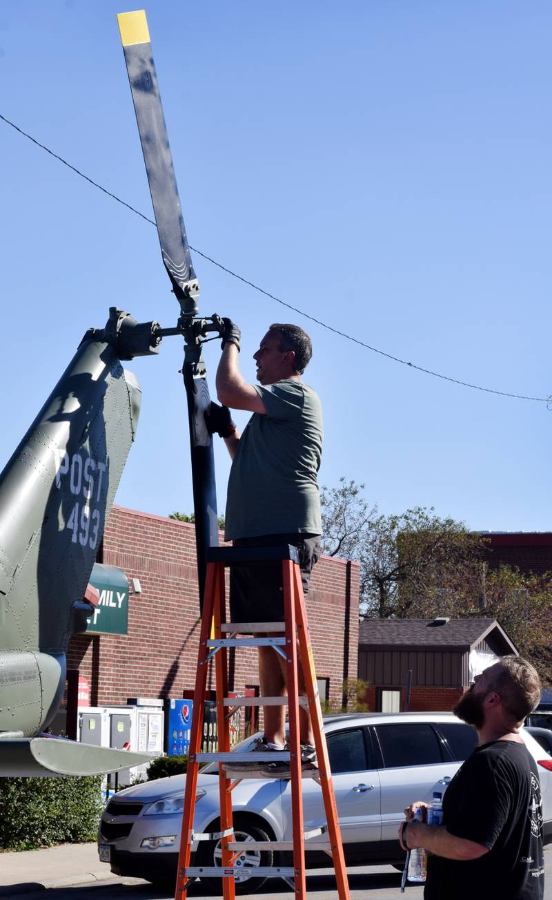 Crews from Midwest Aerospace prepare a Huey helicopter monument on Sept. 30 in Baxter.