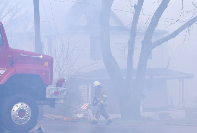 Firefighters from multiple agencies in Jasper and Polk Counties respond to a house fire on Thursday, April 20, near the 300 block of South Walnut Street in Colfax.