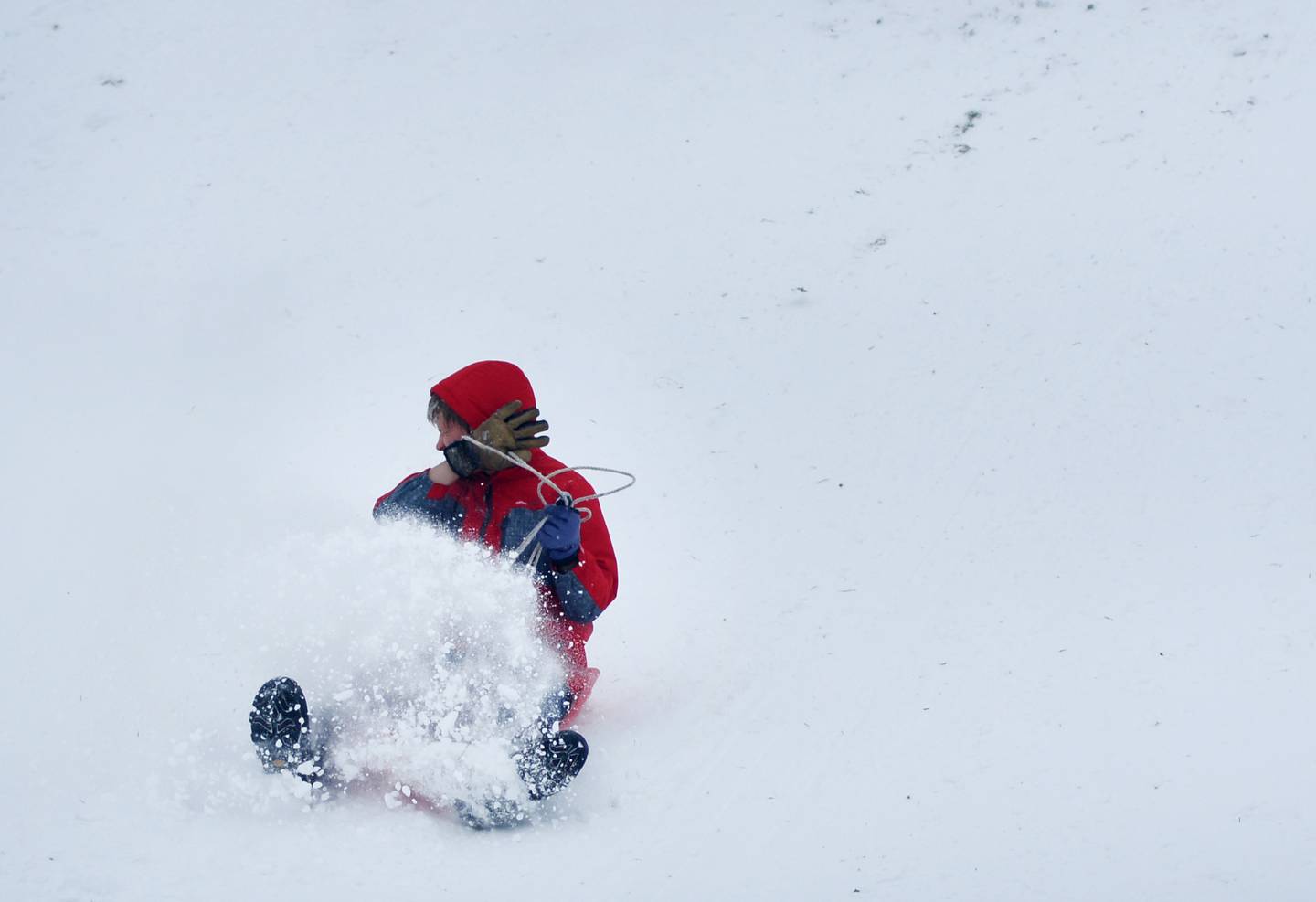 Justus Hodge sleds down a hill at Sunset Park on Sunday, Nov. 30 in Newton.