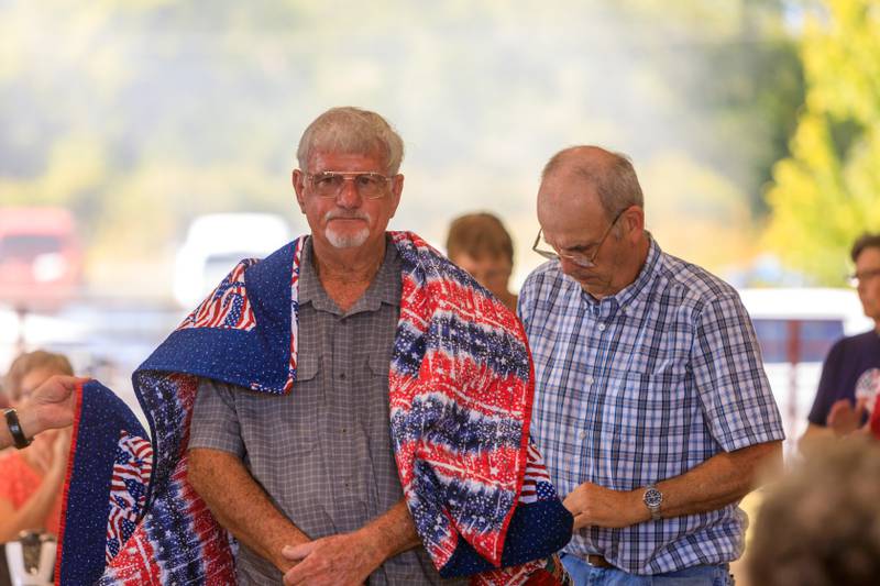 Veterans from Jasper County on July 17 received Quilts of Valor made by a 4-H quilting group and volunteers. The quilts sporting red, white and blue colors were given to veterans during a ceremony inside the pavilion at the Jasper County Fair. Photo by Fermin Iturbide.