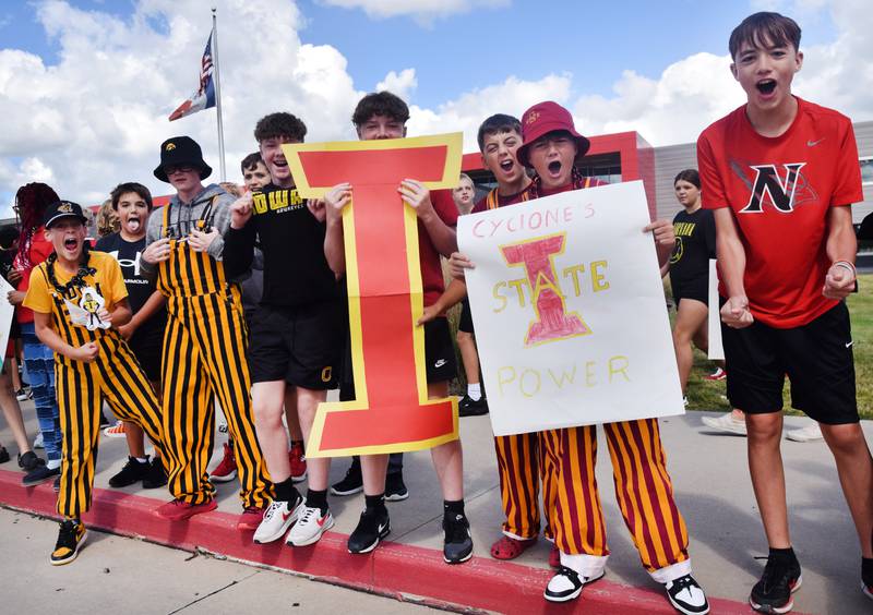 Students wearing Cyclone and Hawkeye apparel pose for pictures on Sept. 4 outside Berg Middle School. The whole study body was invited to welcome RVTV to town.