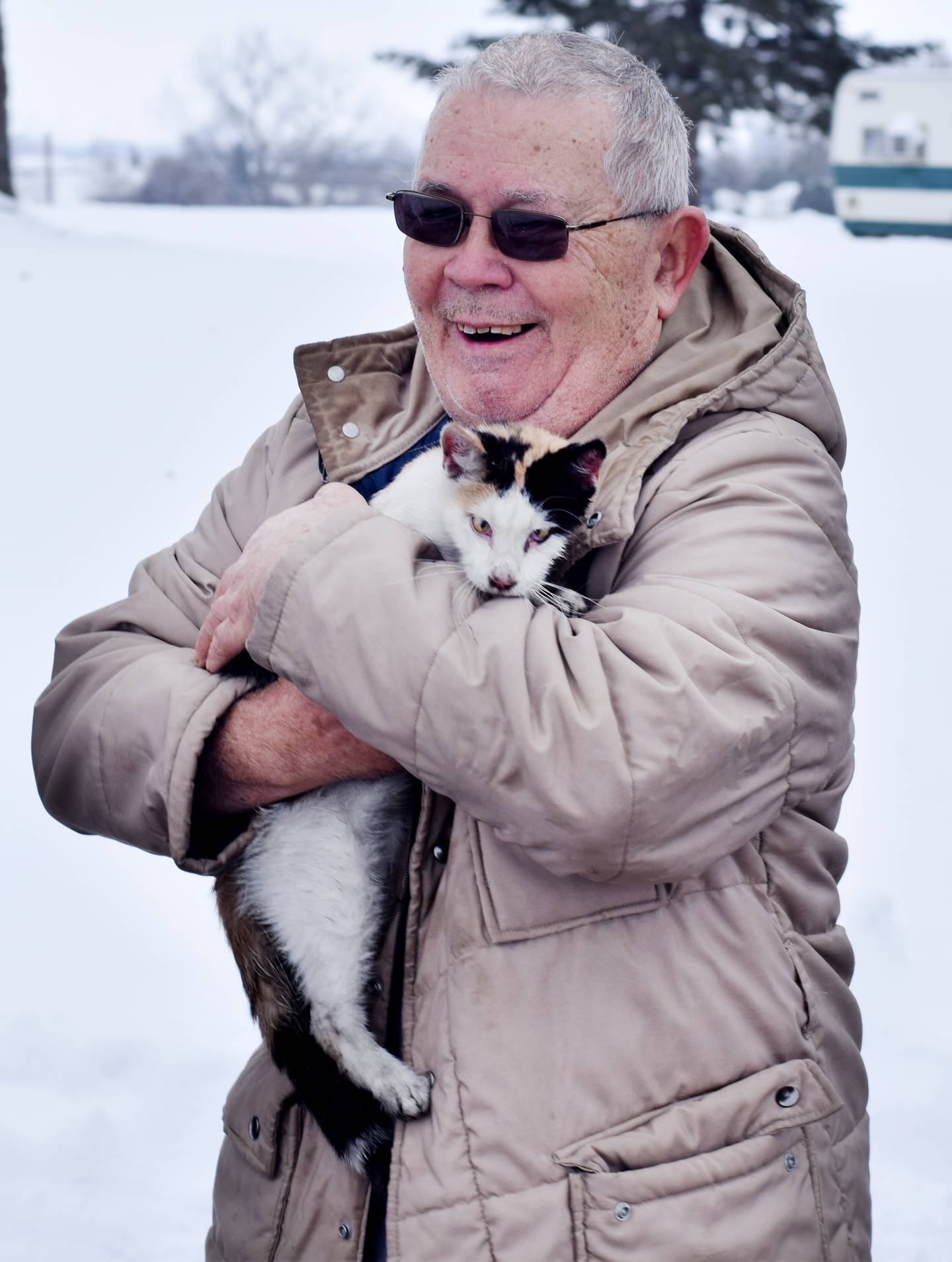 Bruce Doland reacts to seeing one of his cats survive a house fire on Jan. 11 near the 1600 block of East Seventh Street South in Newton.
