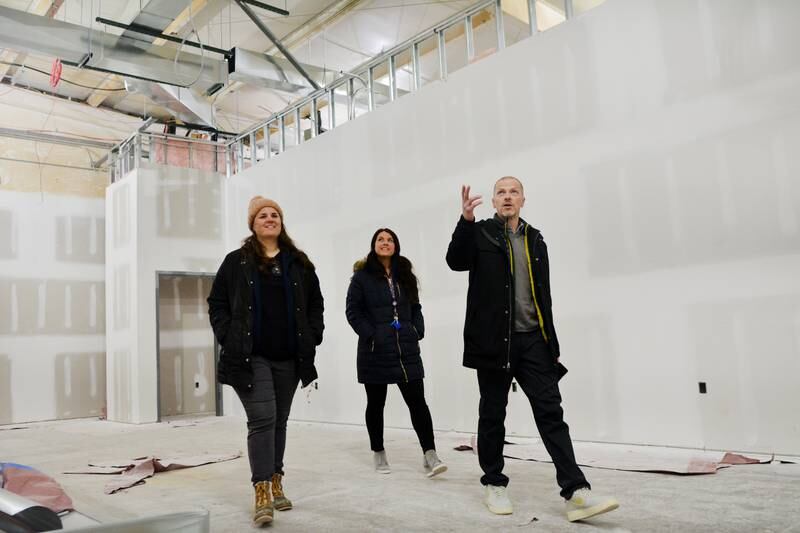 From left: Kate Van Manen, Nicole Van Wyk and Michael Lauterbach tour through a classroom under construction at the Newton Christian School. When fully completed, the class will be home to seventh- or eighth-grade students. The expansion is part of the school's Dream Big project.