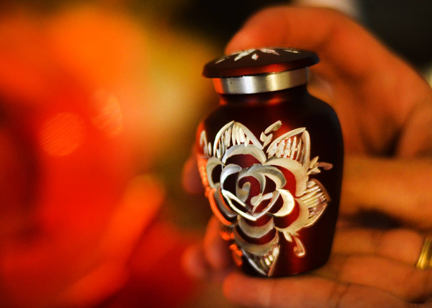 Shannon Allen, of Newton, holds a small urn containing her daughter's ashes. Kristen Ewing, Allen's daughter, died at age 25 of a fentanyl overdose. Since then, her mother has lobbied legislators to pass laws that hold drug dealers accountable so that other mothers do not experience the pain she went through after losing her daughter.