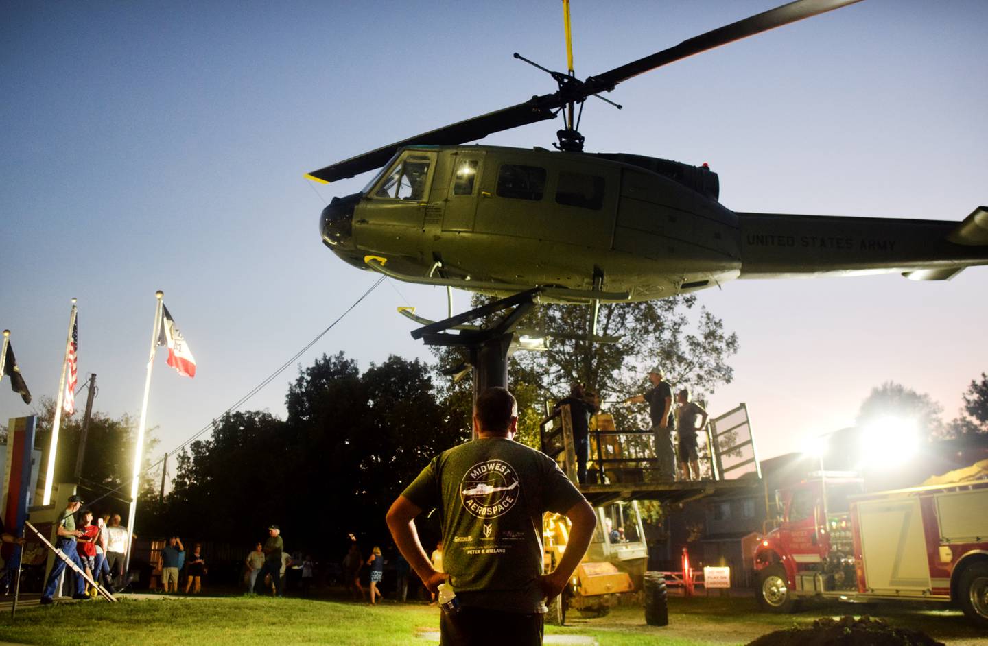 Joe Giannini of Midwest Aerospace watches as crews install the Huey helicopter monument on Sept. 30 in Baxter.