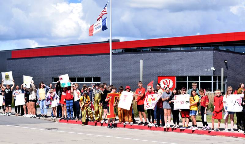 Students wearing Cyclone and Hawkeye apparel pose for pictures on Sept. 4 outside Berg Middle School. The whole study body was invited to welcome RVTV to town.