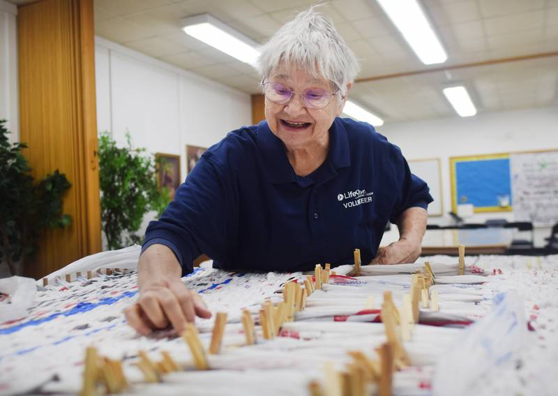 Jan Lewis works on a sleeping mat made of recycled plastic grocery bags on April 12 in First Christian Church. Looms of Love is a group of churchgoers who spend a few hours a week making the mats using a wooden loom to weave the grocery bags together.