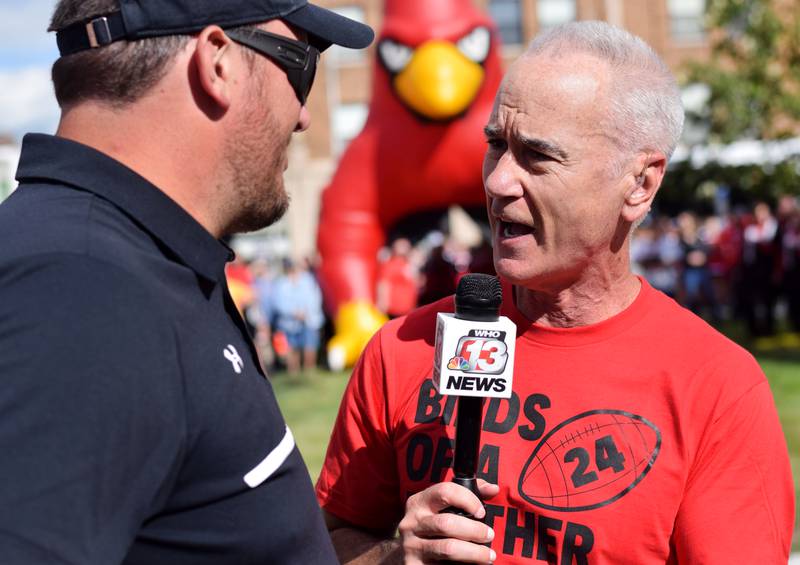 Keith Murphy of WHO 13 on Sept. 4 speaks with Newton Head Football Coach Andy Swedenhjelm during his live broadcast on the lawn of the Jasper County Courthouse in downtown Newton. Residents gathered for a Newton pep rally and RVTV festivities.