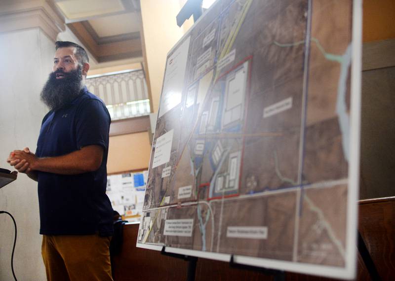 Supervisor Brandon Talsma speaks to community members on July 30 at the rotunda of the Jasper County Courthouse to celebrate the finalized joint land purchase with Iowa Interstate Road, which will be building a rail park northeast of Newton.