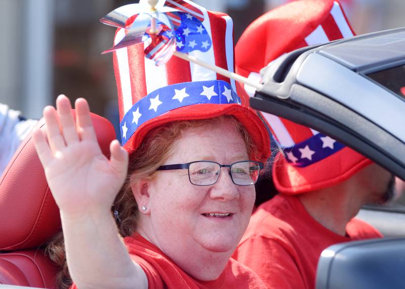 Laura Jochems, of Crazy Redhead Quilting, waves to passersby during the Fourth of July Parade in downtown Newton in 2021.