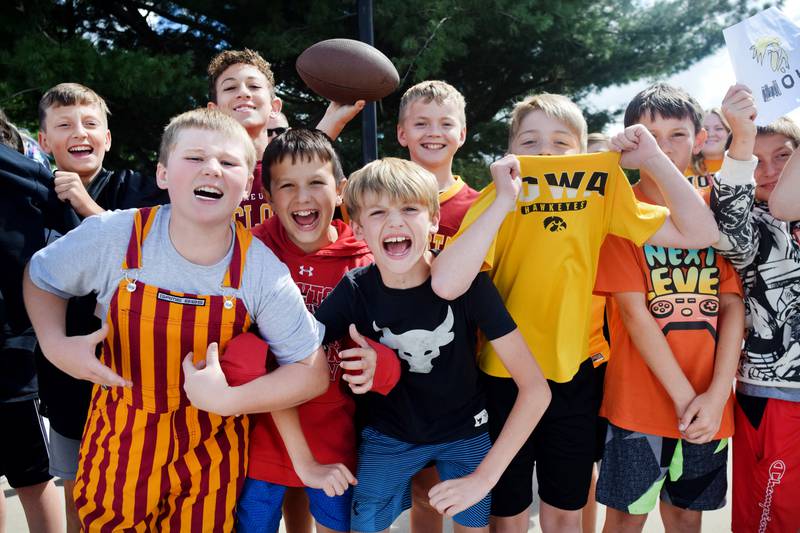 Students wearing Cyclone and Hawkeye apparel pose for pictures on Sept. 4 outside Berg Middle School. The whole study body was invited to welcome RVTV to town.