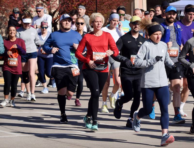 Runners, walkers and young bikers take off for the Run For Her Life 5K organized by nonprofit Phoenix Phase Initiative on April 29 at Legacy Plaza in Newton.