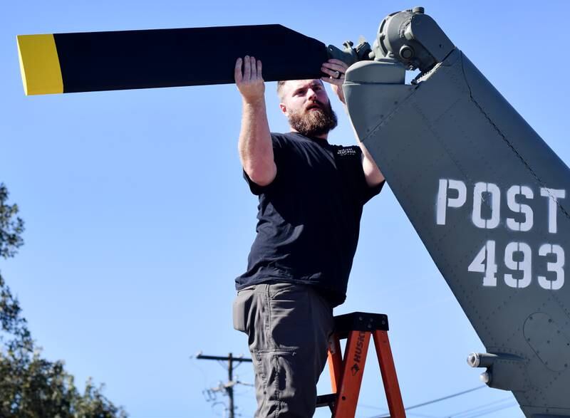 JT Mullins of Midwest Aerospace connects the tail rotor to a Huey helicopter on Sept. 30 in Baxter.