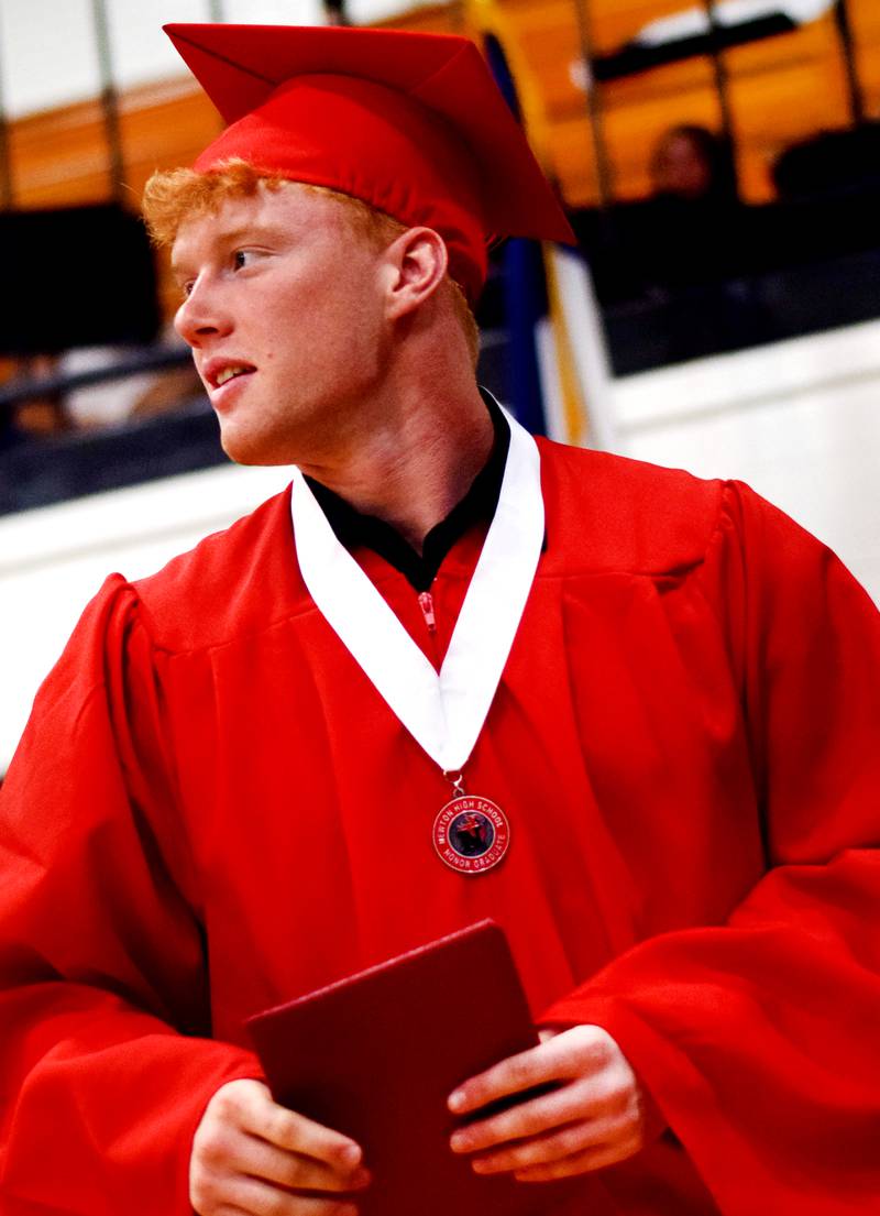 The Newton High School Class of 2024 seniors walk the stage during commencement on May 19 inside the high school gymnasium.
