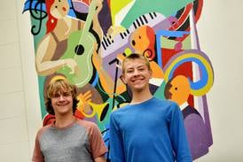 Two NHS vocalists performing All-State Chorus concert