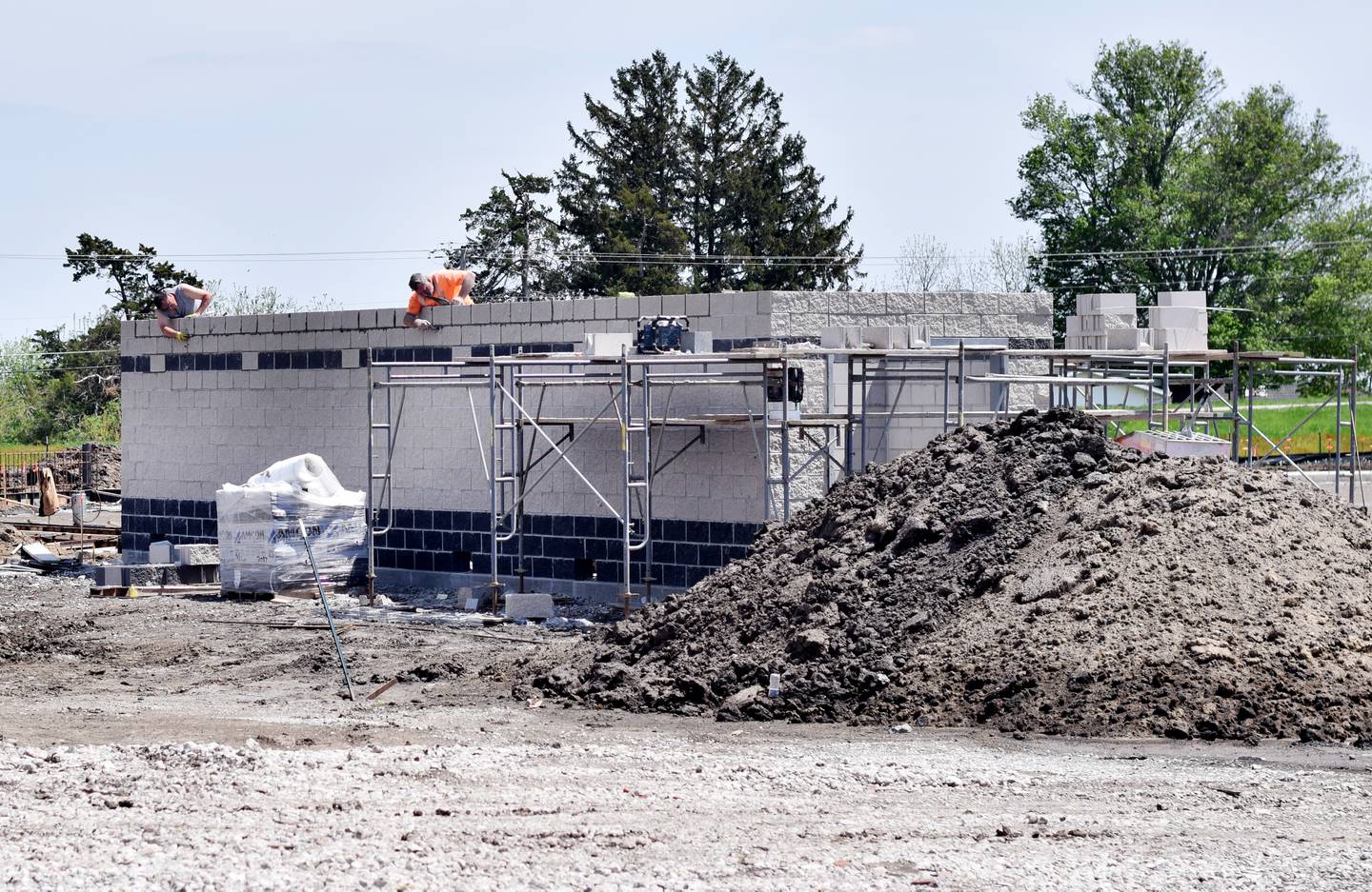 Edge Commercial contractors work on the home team dugout of the new Newton baseball stadium on May 10. School officials are hopeful the stadium can be finished before July.