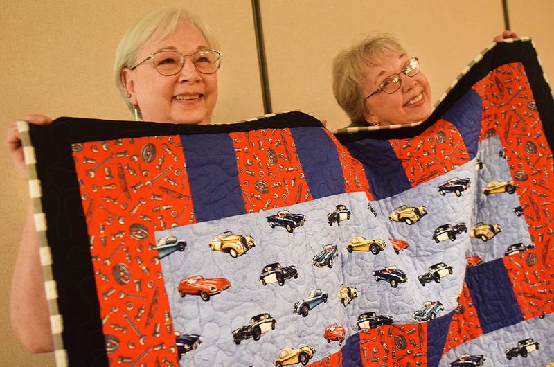 Members of the 1/4-Inch Quilters prepare for the upcoming quilt auction that will be held 6 p.m. Nov. 10, 2023 at the DMACC Newton Campus. The auction is a fundraising for the Salvation Army.