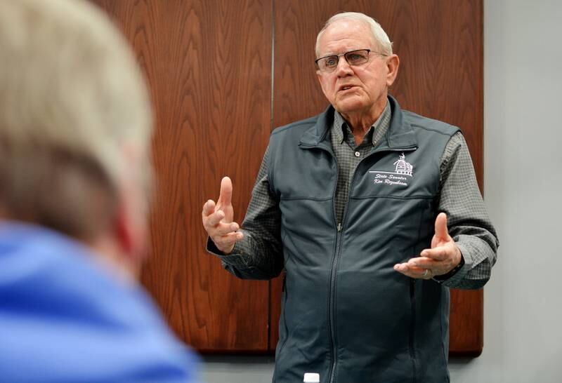 Sen. Ken Rozenboom speaks with constituents during a legistlative gathering hosted by the League of Women Voters of Jasper County in the meeting room of the Newton Public Library.